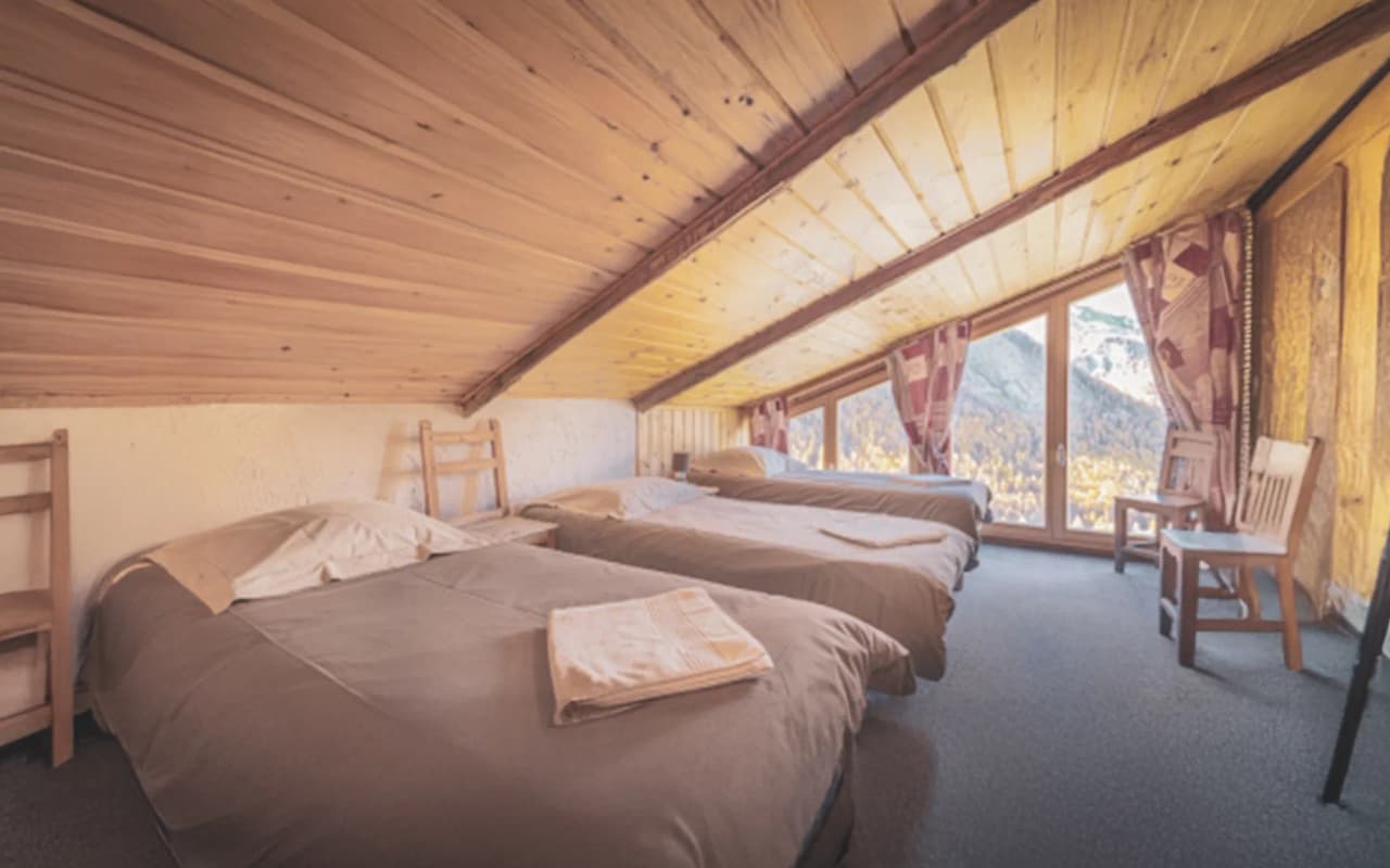 Comfortable rooms with wooden ceilings and panoramic views of the surrounding mountains.