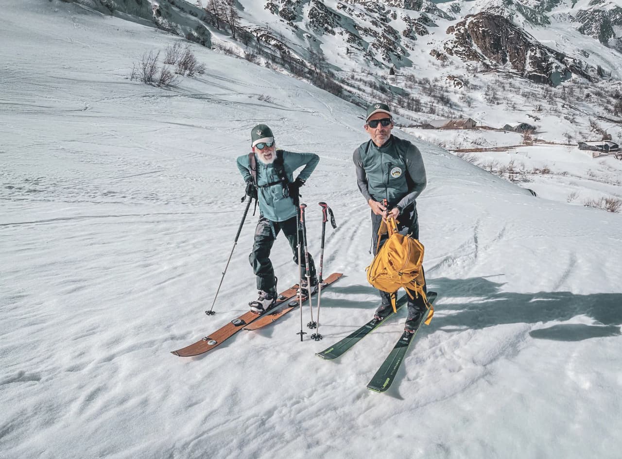 Two skiers on a snow-covered path over the Great Saint Bernard Pass, ready for an alpine adventure.