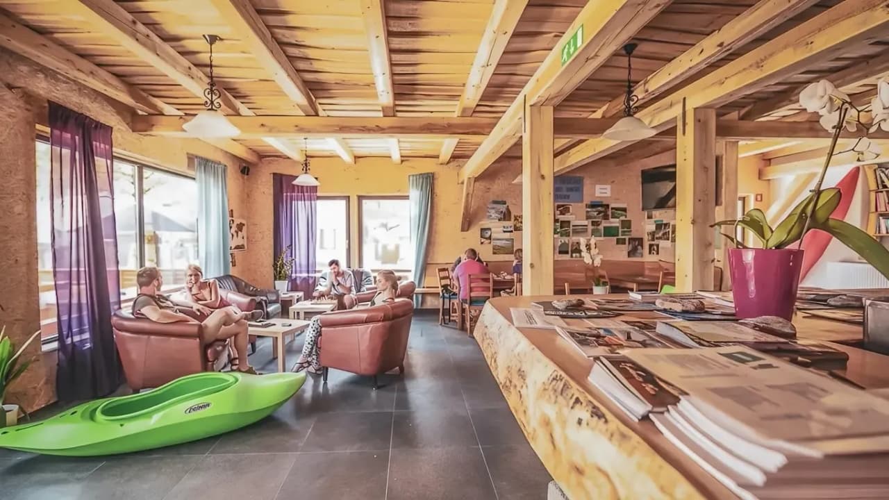 A cosy space with sofas, a green kayak and views of Slovenian rivers.