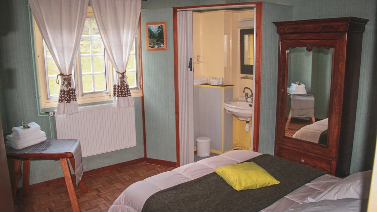 Comfortable room with bright windows and warm decor, ideal after a hike.
