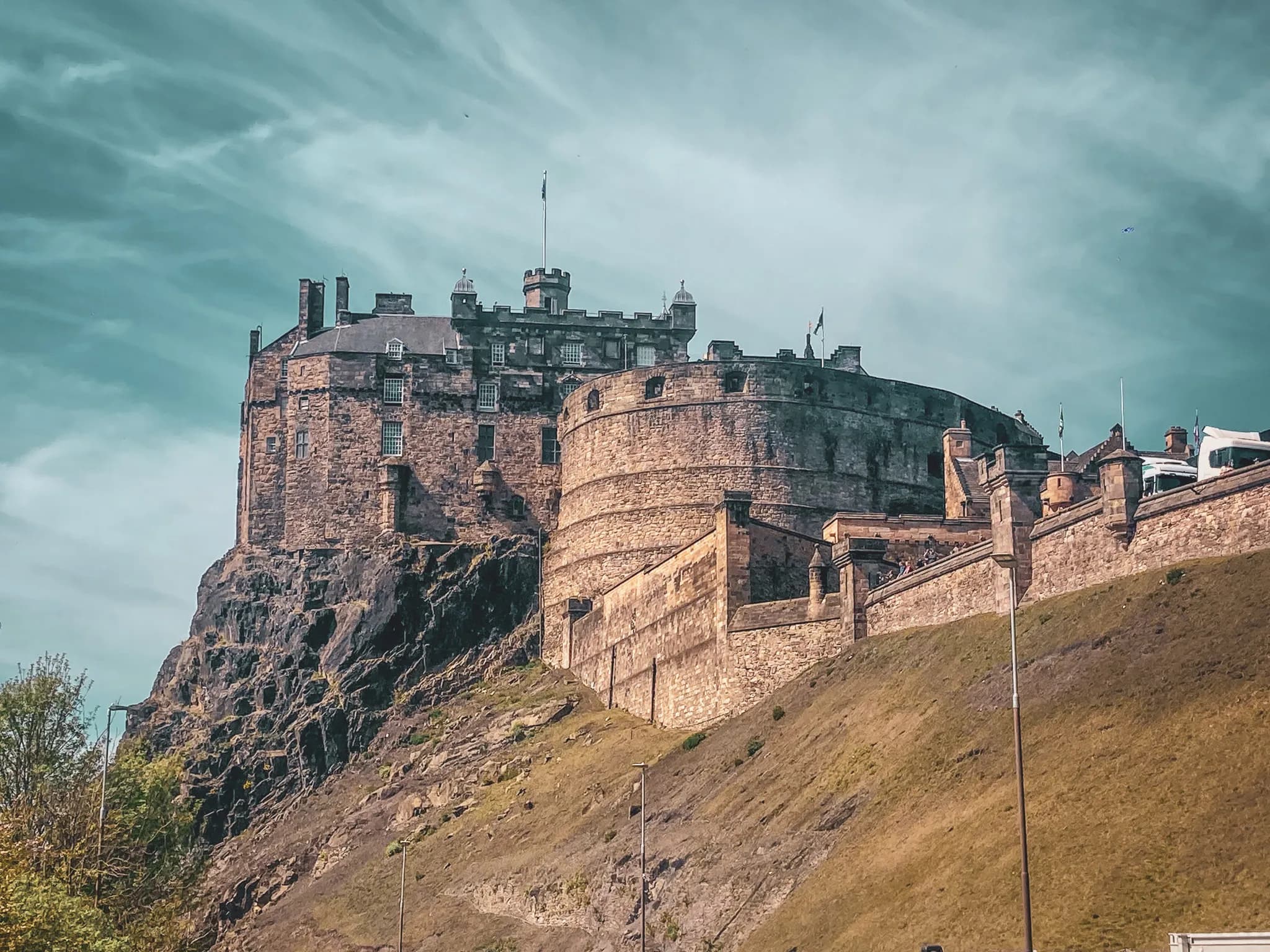 A majestic castle on a rocky outcrop, with a luminous sky as a backdrop, inviting adventure.