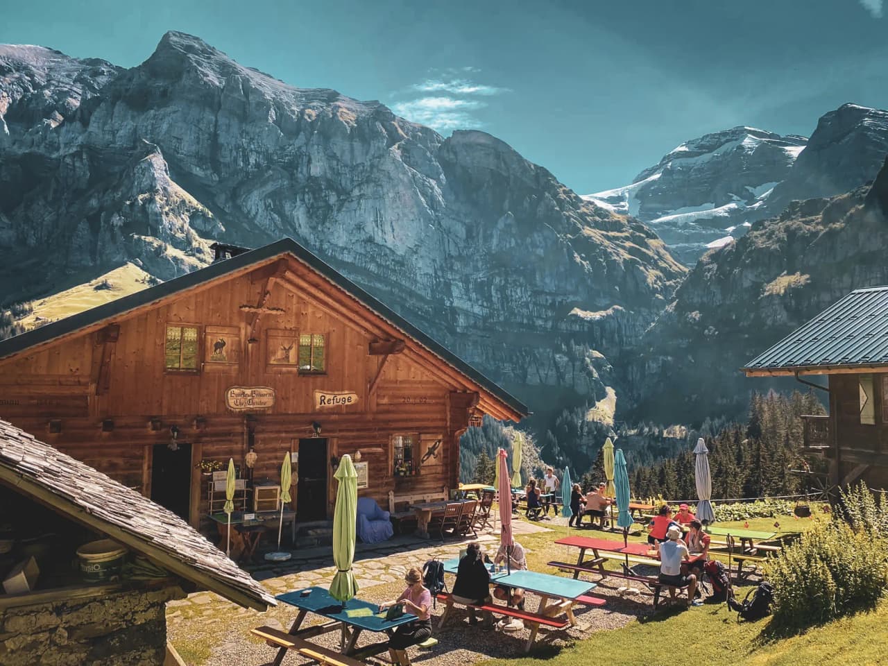 Cosy alpine Mountain hut with wooden terraces, surrounded by majestic mountains and exceptional natural scenery.