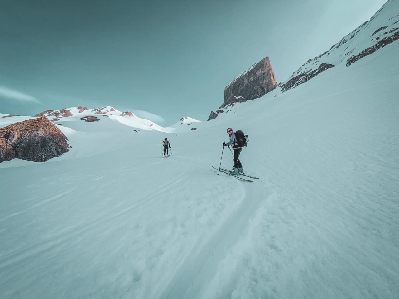 Ski touring on a vast glacier, with majestic mountains in the background. A breathtaking alpine adventure.