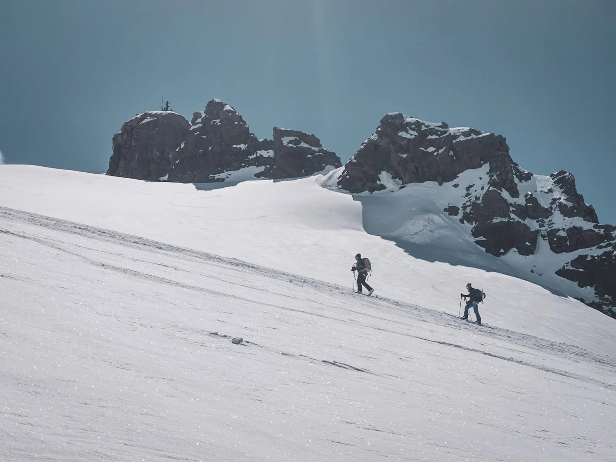 Two skiers are ski touring one of the peaks of Mont Rose at over 4000m.