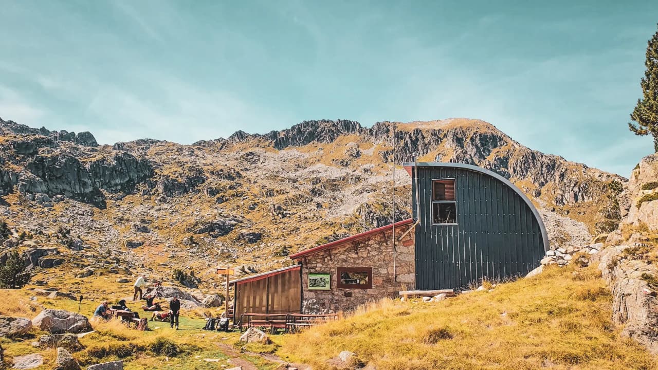 A typical alpine Mountain hut in the heart of the mountains, surrounded by majestic rolling countryside.