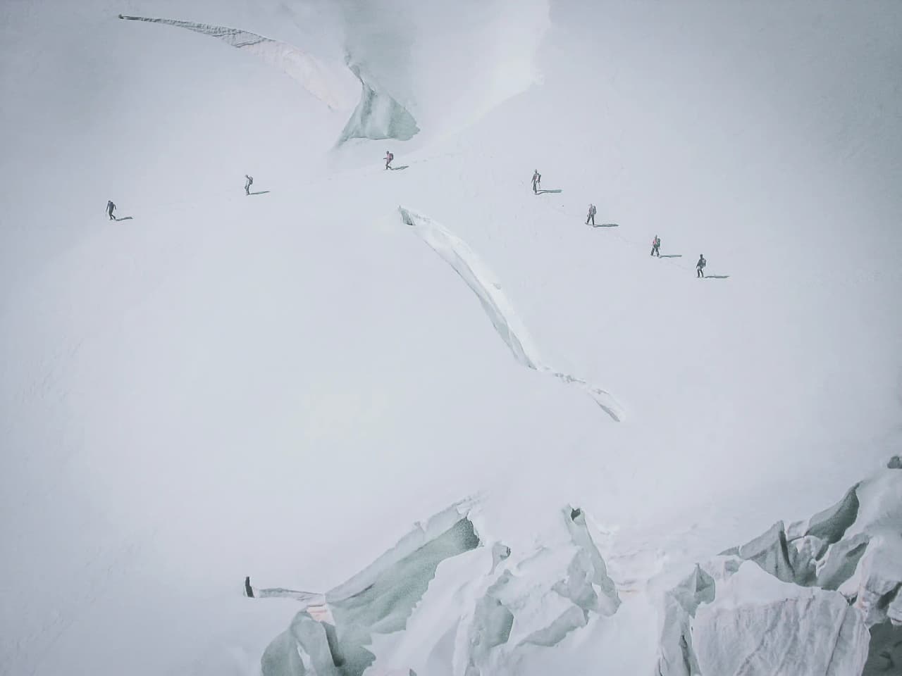 Hikers crossing the Aletsch glacier, surrounded by breathtaking icy landscapes.