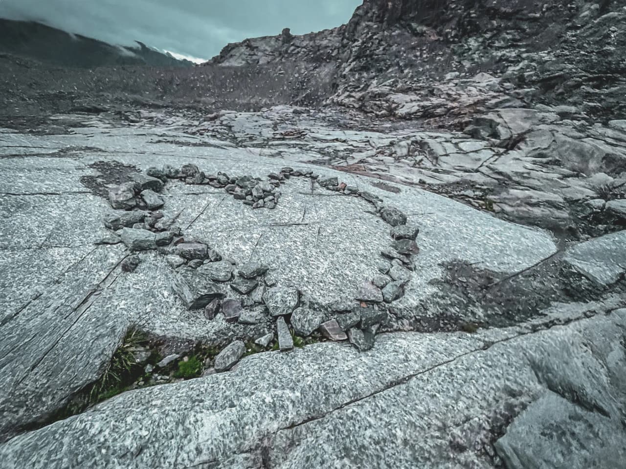 A heart made of stones on a rocky landscape, a symbol of love for the mountains.