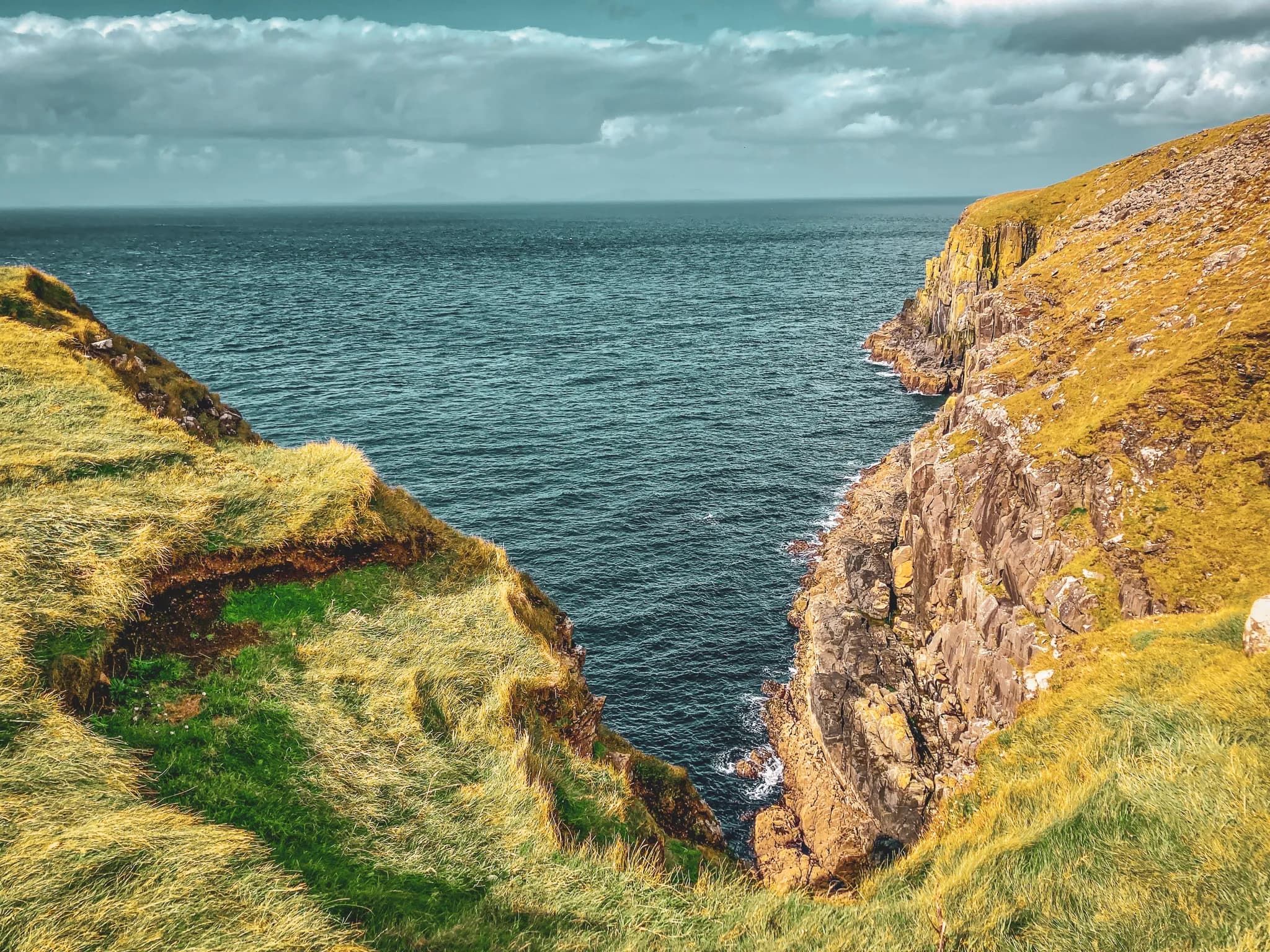 Impressive cliffs on the Isle of Skye, overlooking a deep blue sea, breathtaking scenery.