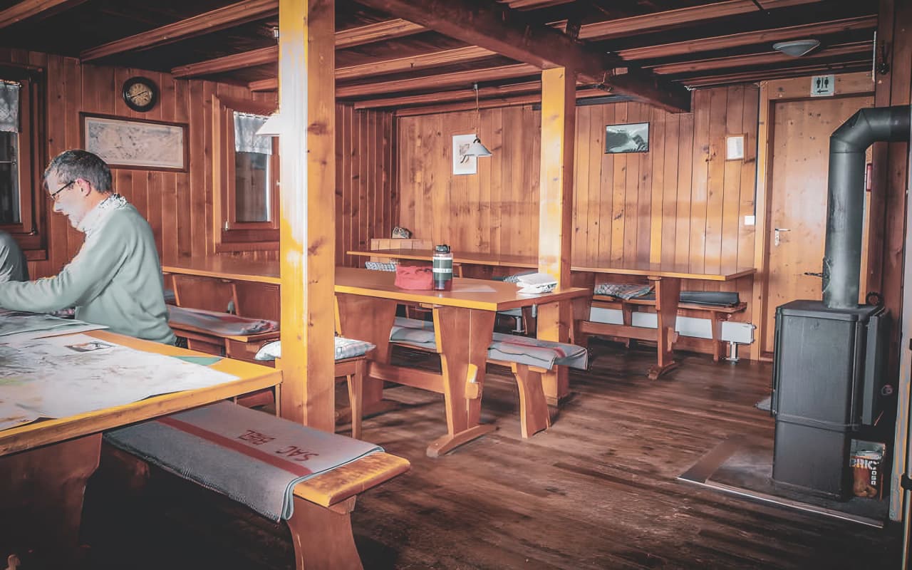 The warm interior of a wooden Mountain hut invites you to take a break after a glacier hike.