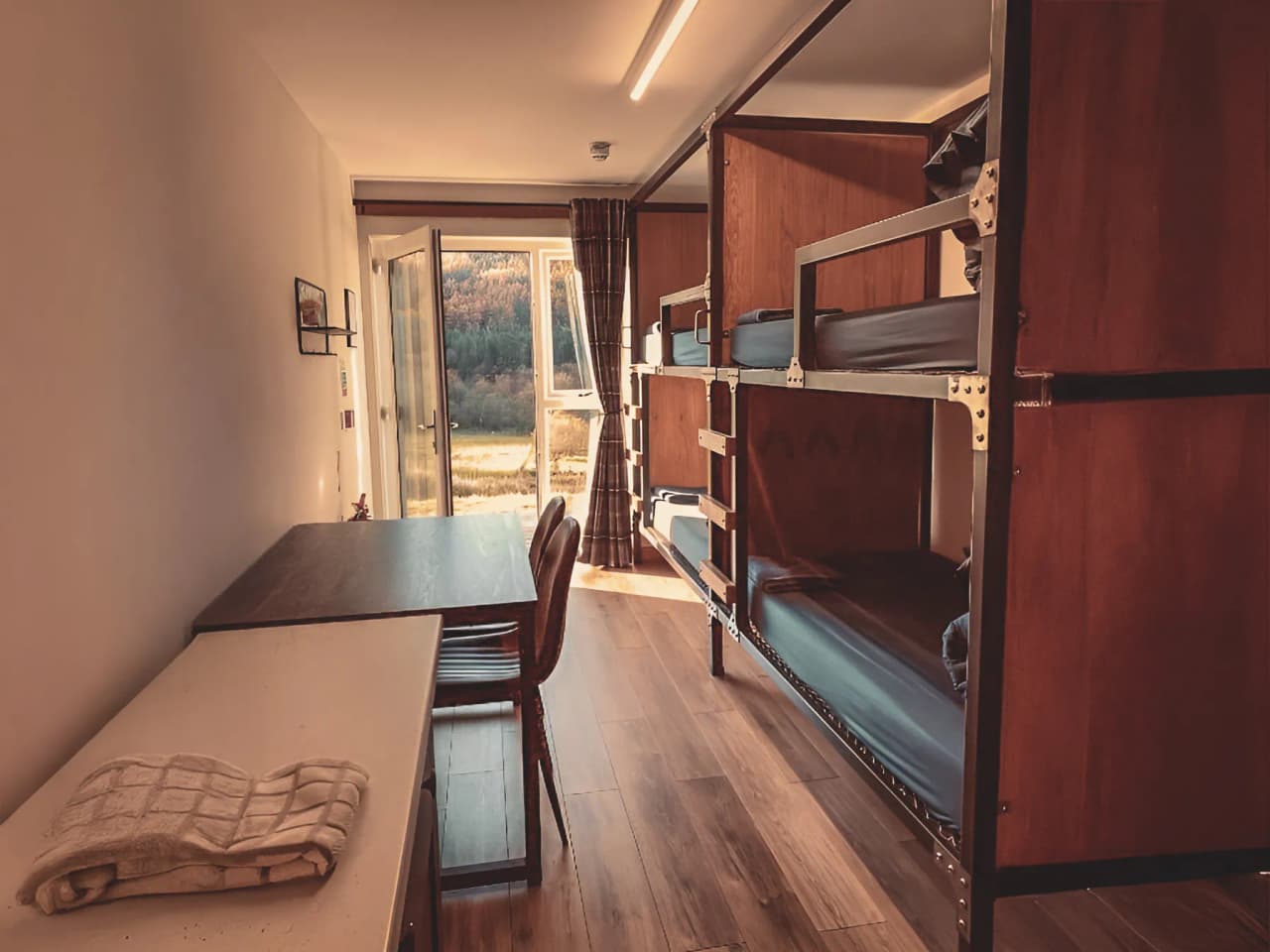 Gezellige kamer met stapelbed en rustgevend uitzicht op de Schotse Hooglanden.
