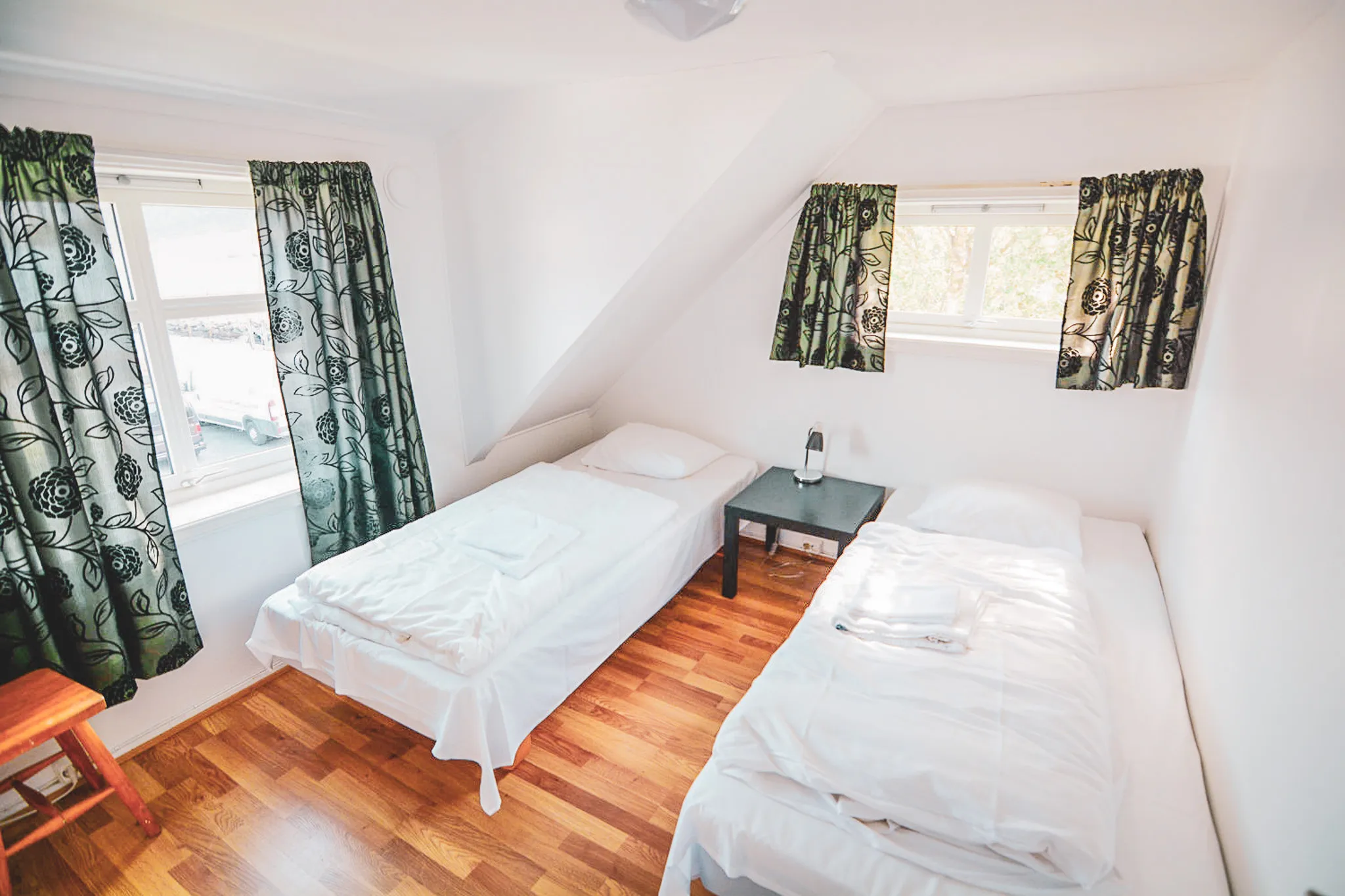 Bright and welcoming room with single beds, perfect for relaxing after your adventure on Senja.