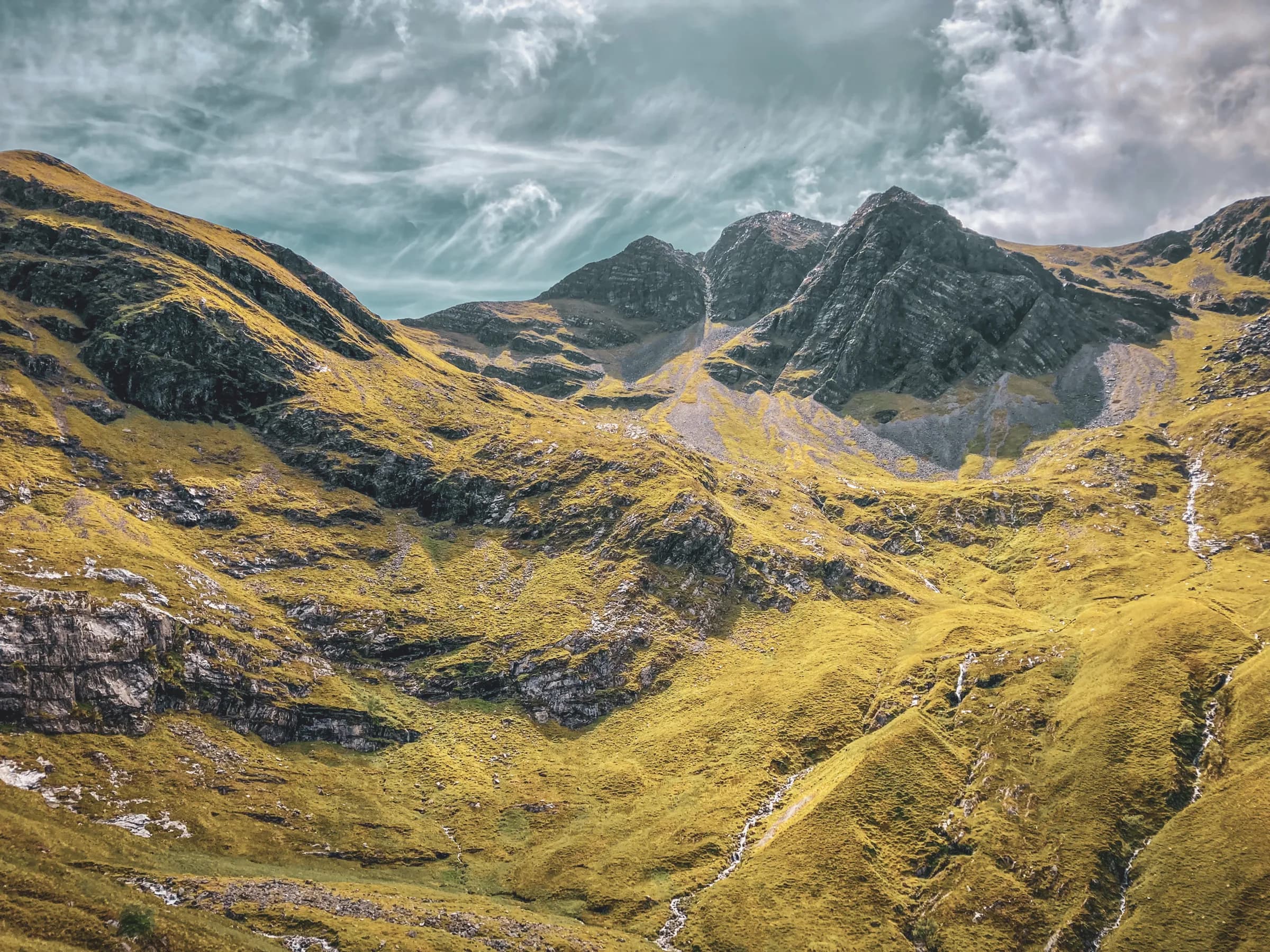 Majestic landscapes of the Scottish Highlands, lush green valleys and imposing peaks.