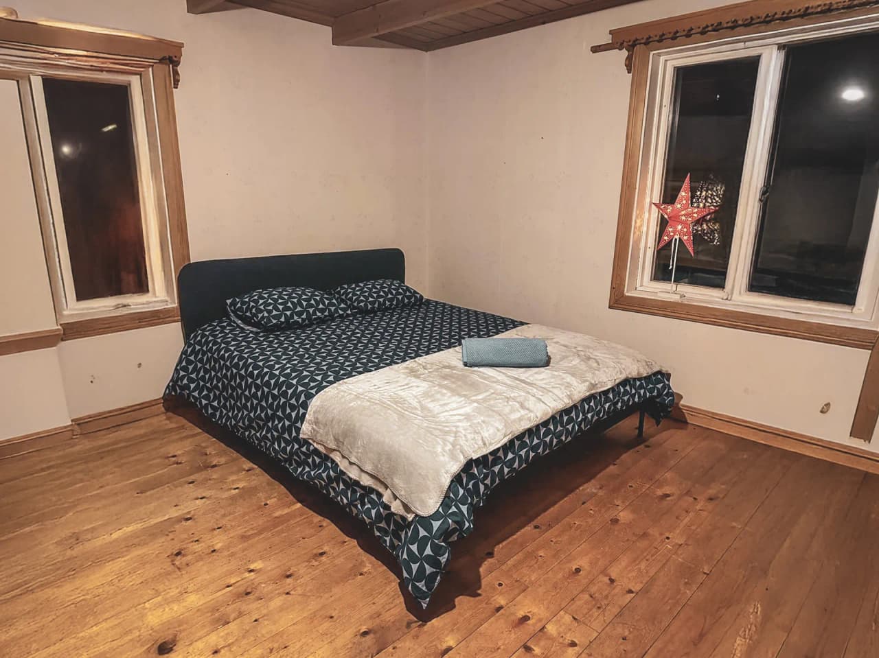 A cosy room with a king-size bed, simply decorated, perfect for relaxing after your Lapland adventure.