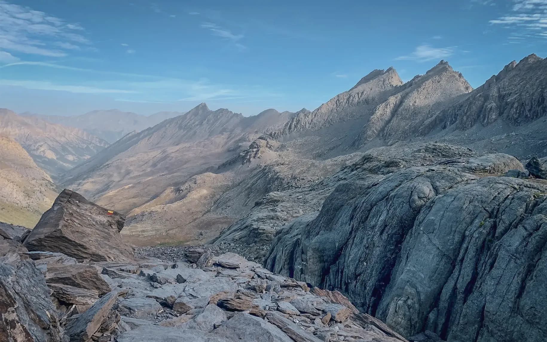 The mountainous landscape of Mont Viso, with its majestic peaks and blue skies, is an invitation to adventure.