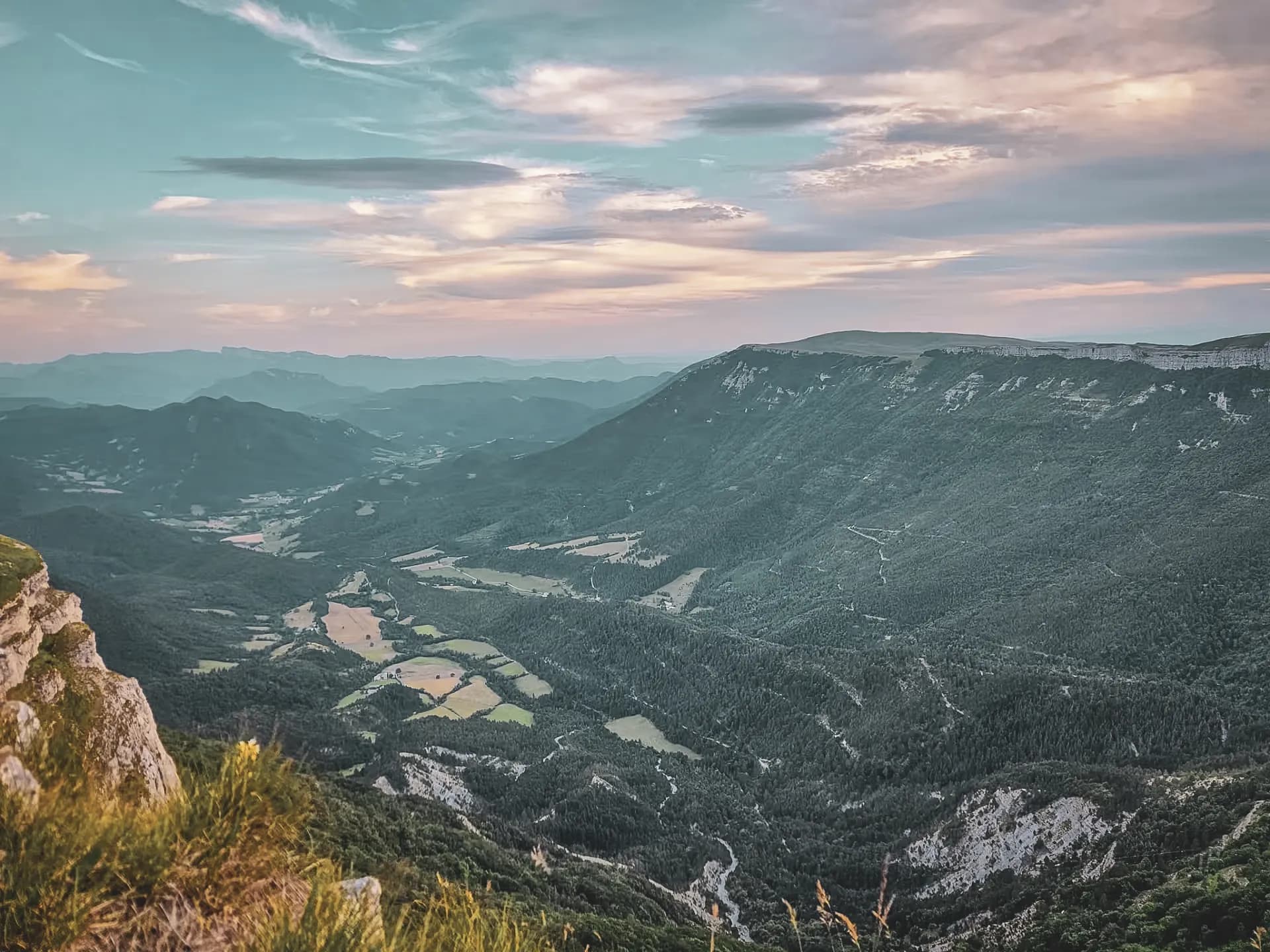 Vercors mountains, lush green landscapes and pastel skies at dusk.