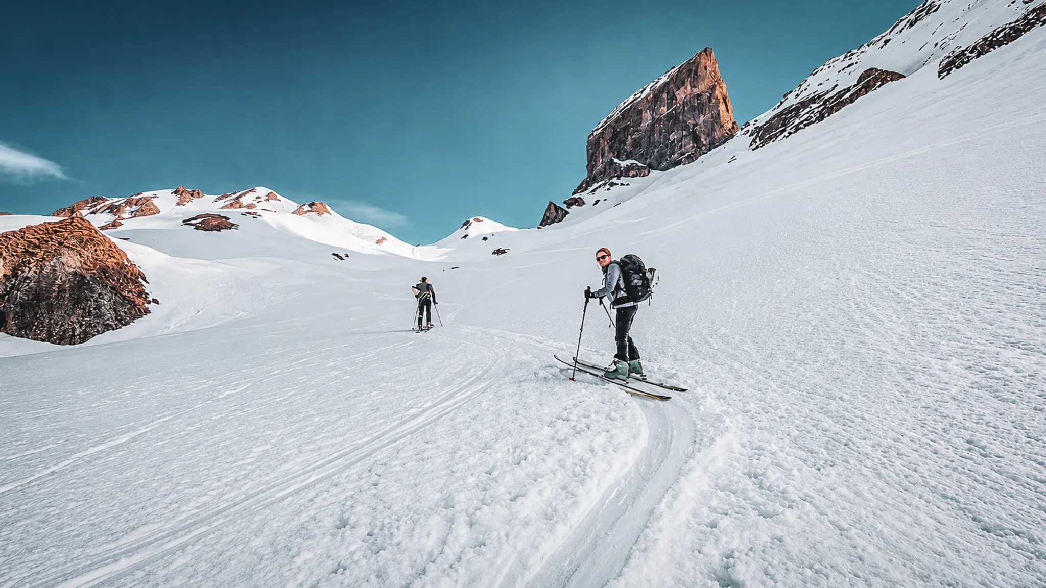 Ski touring on a vast glacier, with majestic mountains in the background. A breathtaking alpine adventure.