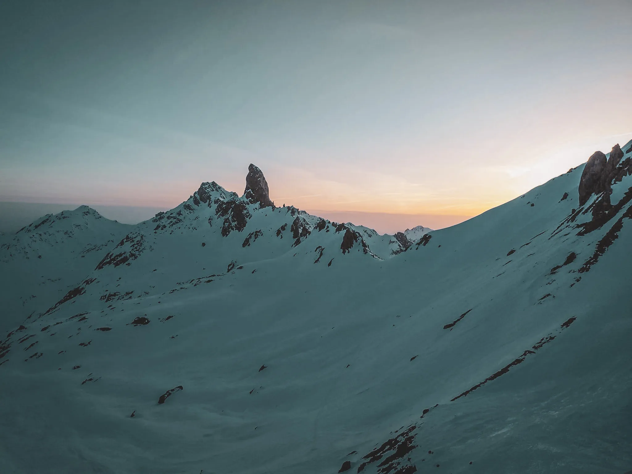 Magnificent alpine scenery under a colourful sky, snow-capped peaks inviting you to adventure.