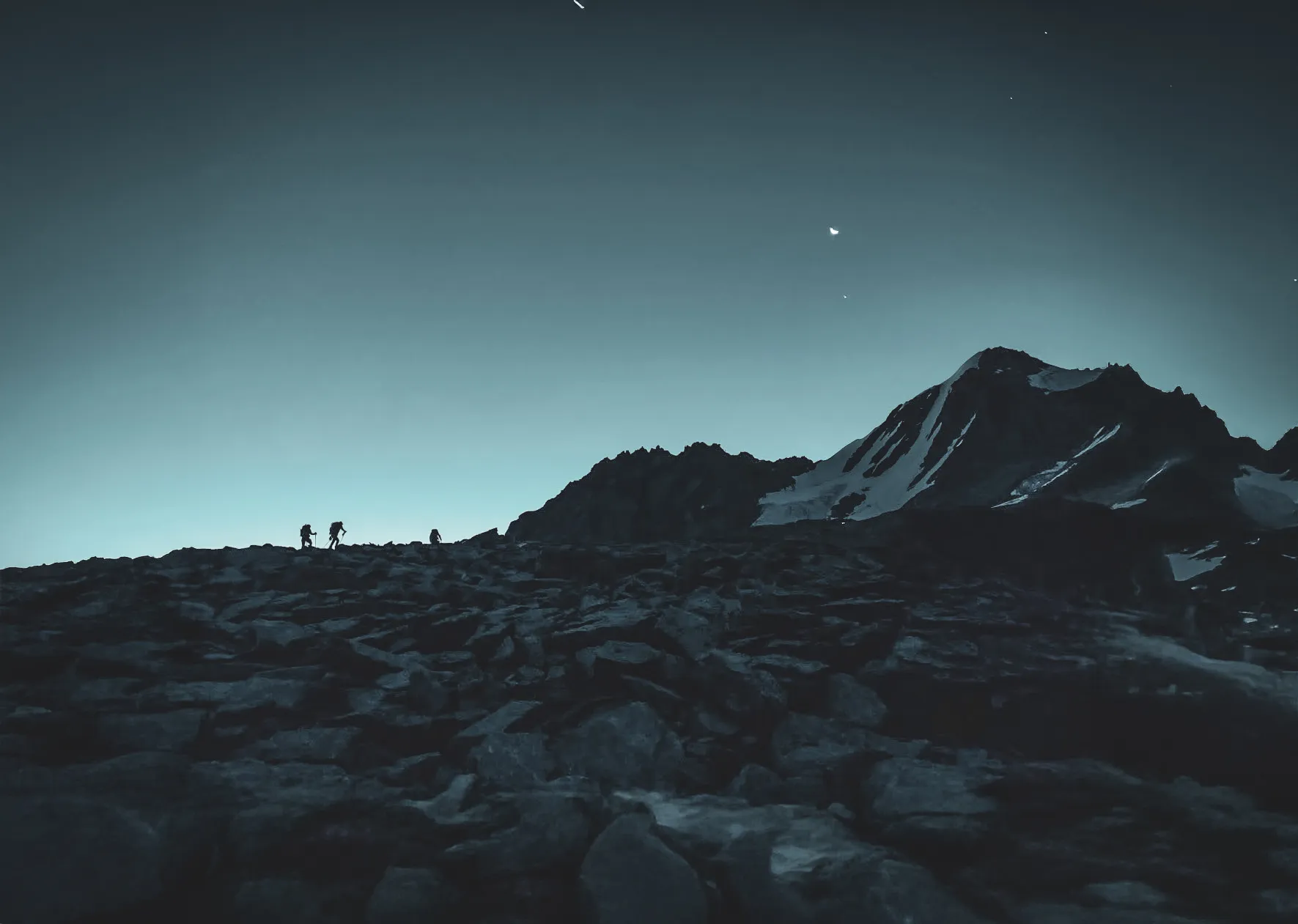 Mountaineers silhouetted against the majestic summit at sunrise, a serene and adventurous atmosphere.