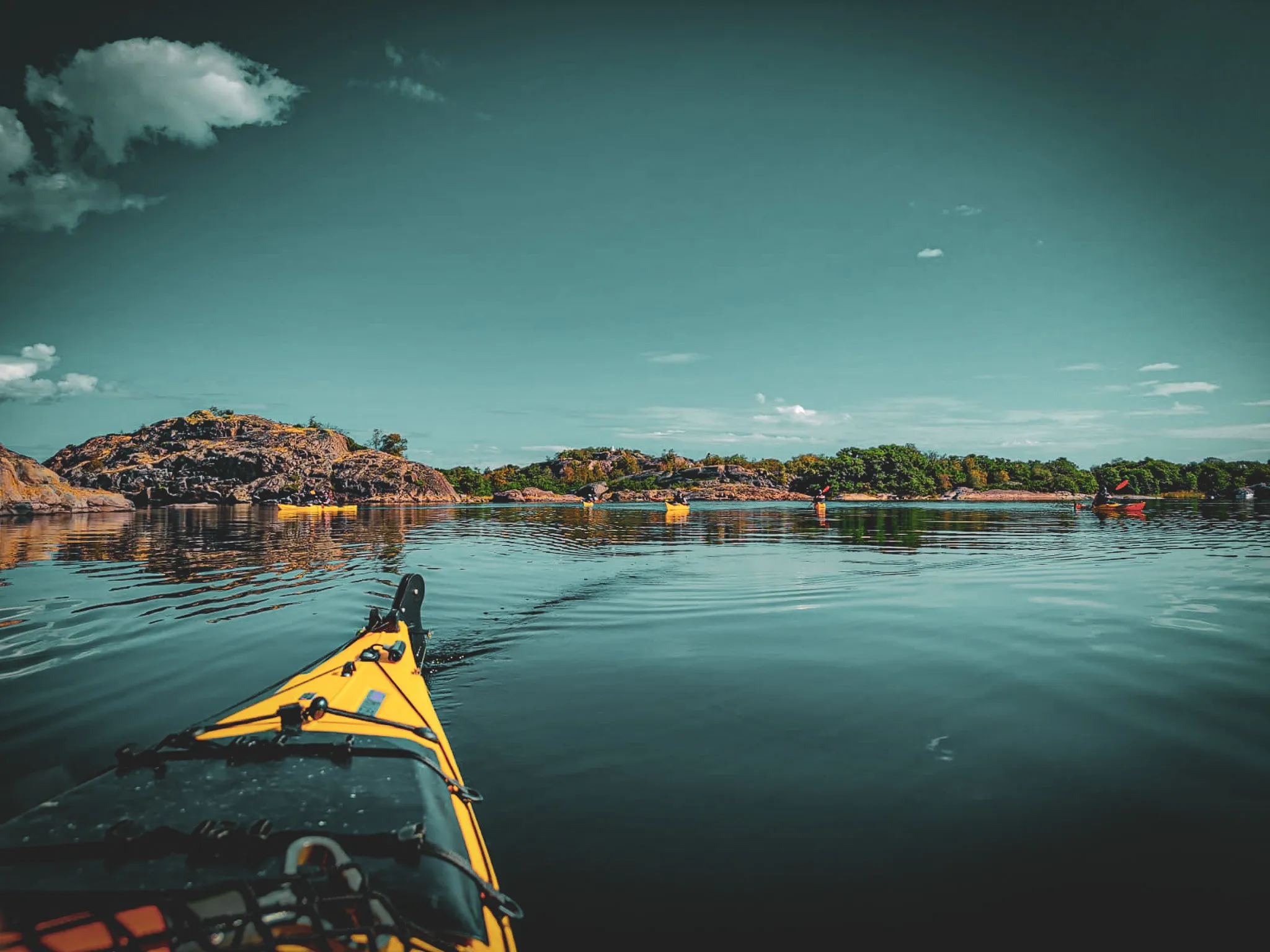 Vibrant kayaking on calm waters, surrounded by wild islands and stunning nature.