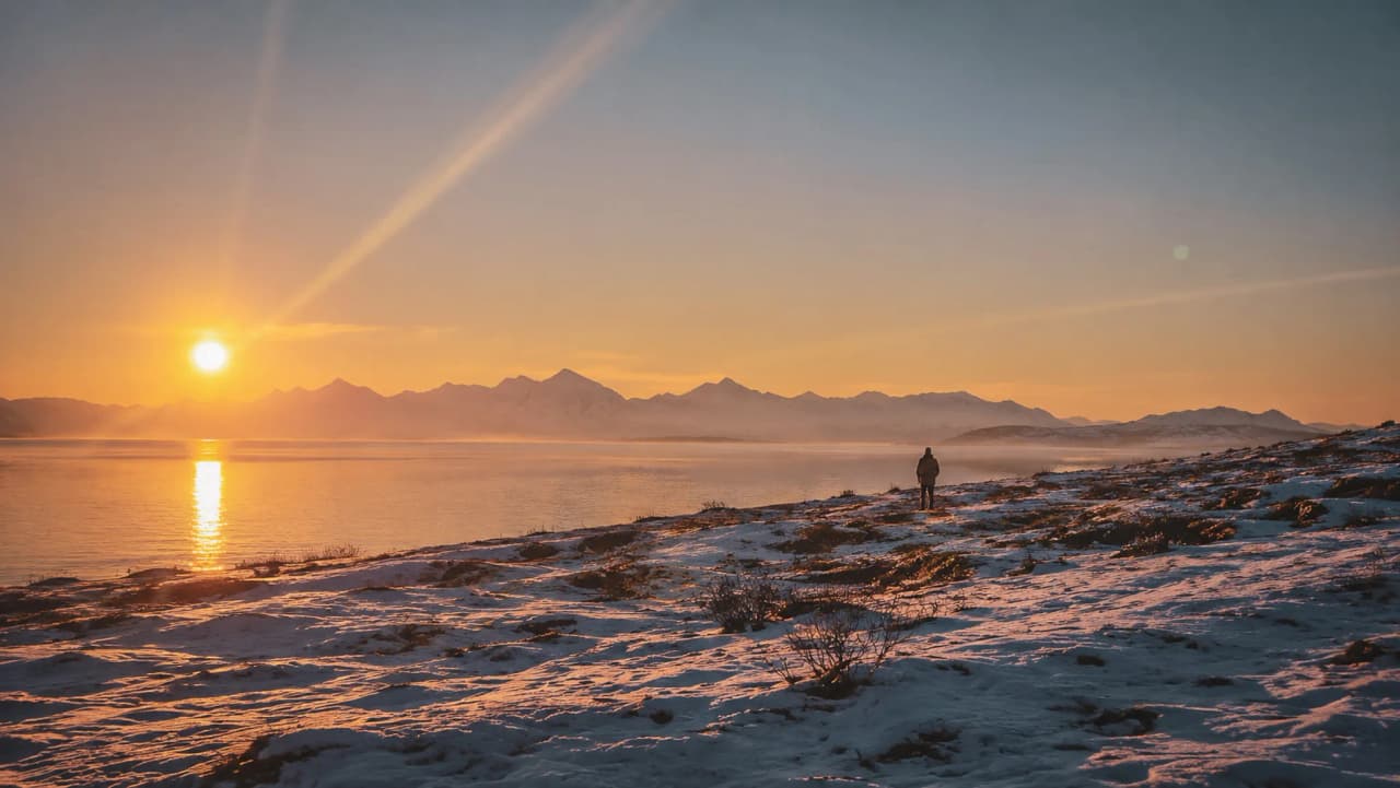 Adembenemende zonsondergang boven de fjorden, een betoverende winter met besneeuwde landschappen en eenzaamheid.