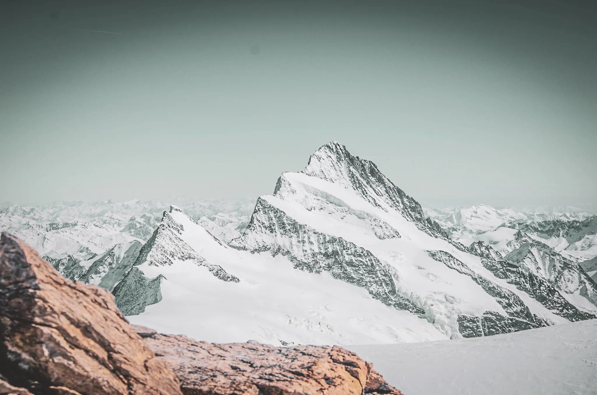 A majestic snow-capped peak overlooking breathtaking Alpine scenery.