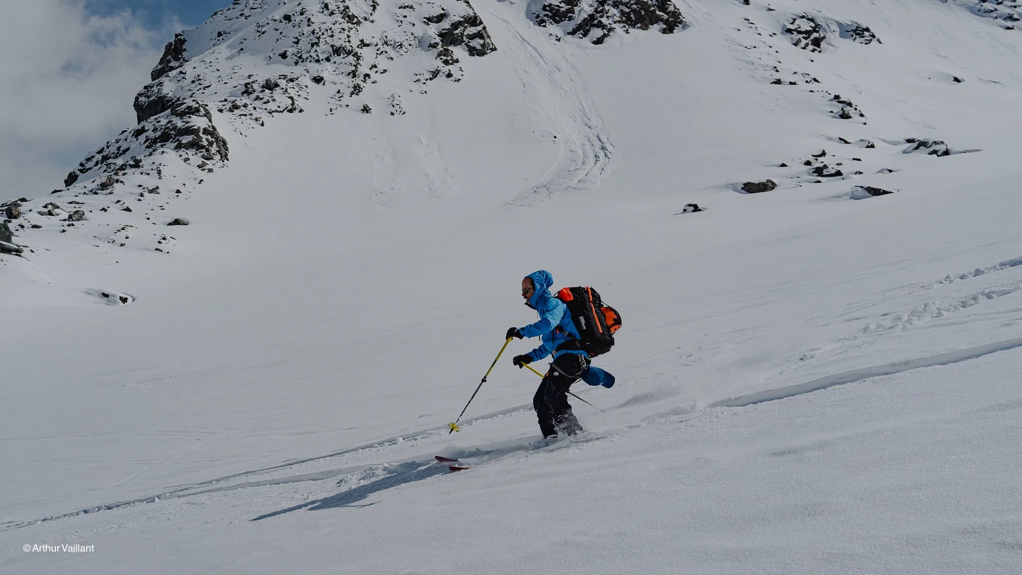Alpine skiing in a snow-covered alpine landscape, with majestic glaciers in the background.