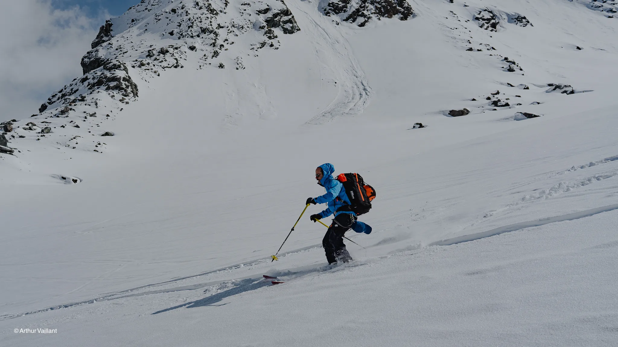 Alpine skiing in a snow-covered alpine landscape, with majestic glaciers in the background.