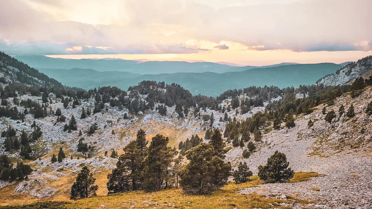 A breathtaking panorama of the Vercors plateaus, blending mountains and lush green valleys.