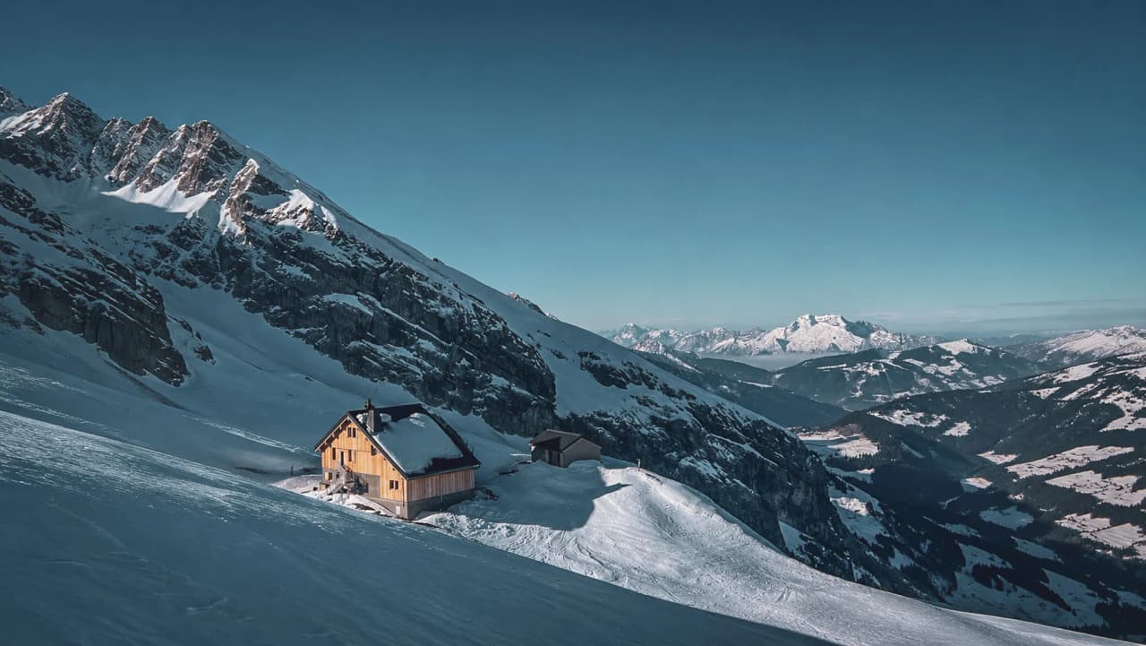 A picturesque mountain hut nestled beneath the snow-capped peaks of the Aravis, inviting you to embark on a ski touring adventure.