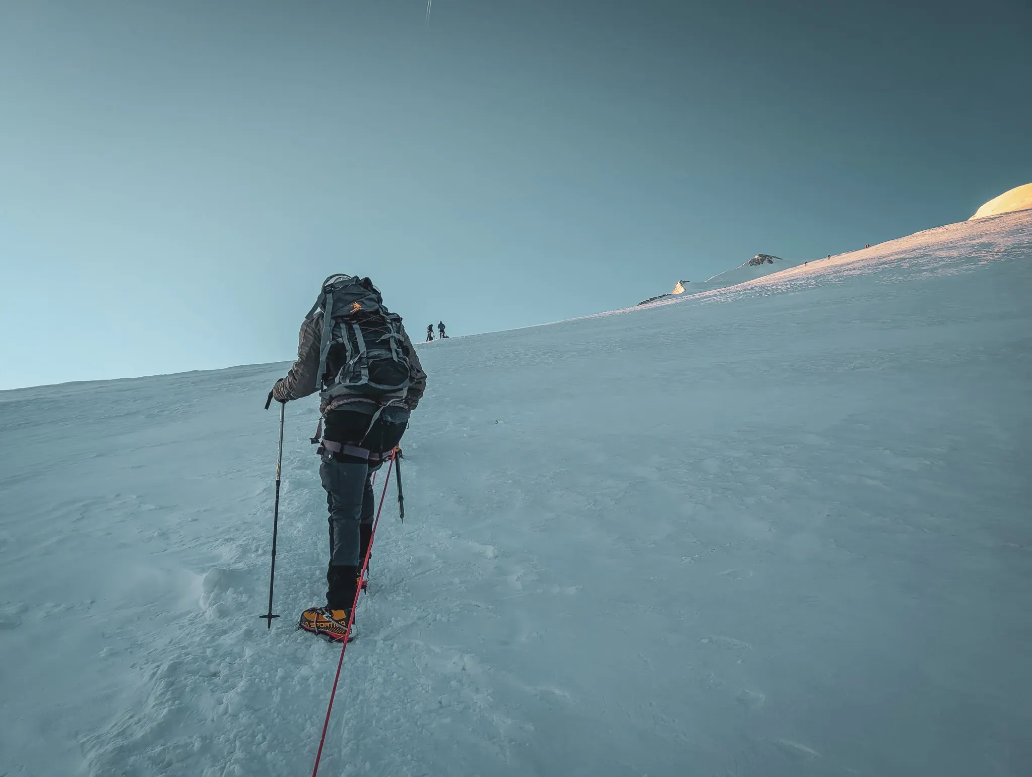 Mountaineer making progress on a glacier, conquering the mythical summit of the Bishorn.