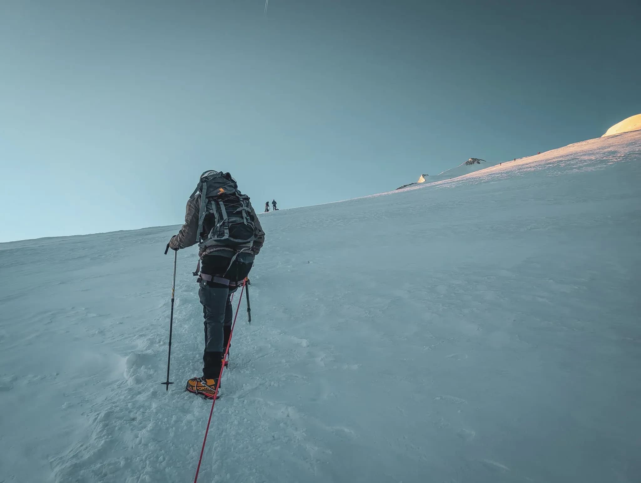 Mountaineer making progress on a glacier, conquering the mythical summit of the Bishorn.