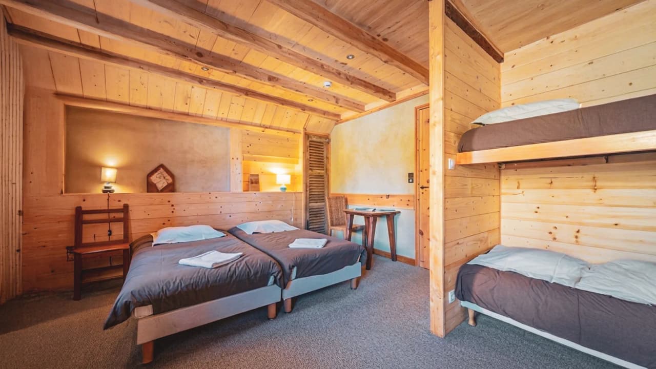 Chambre conviviale en bois, confort moderne pour se ressourcer après une journée d'expédition.