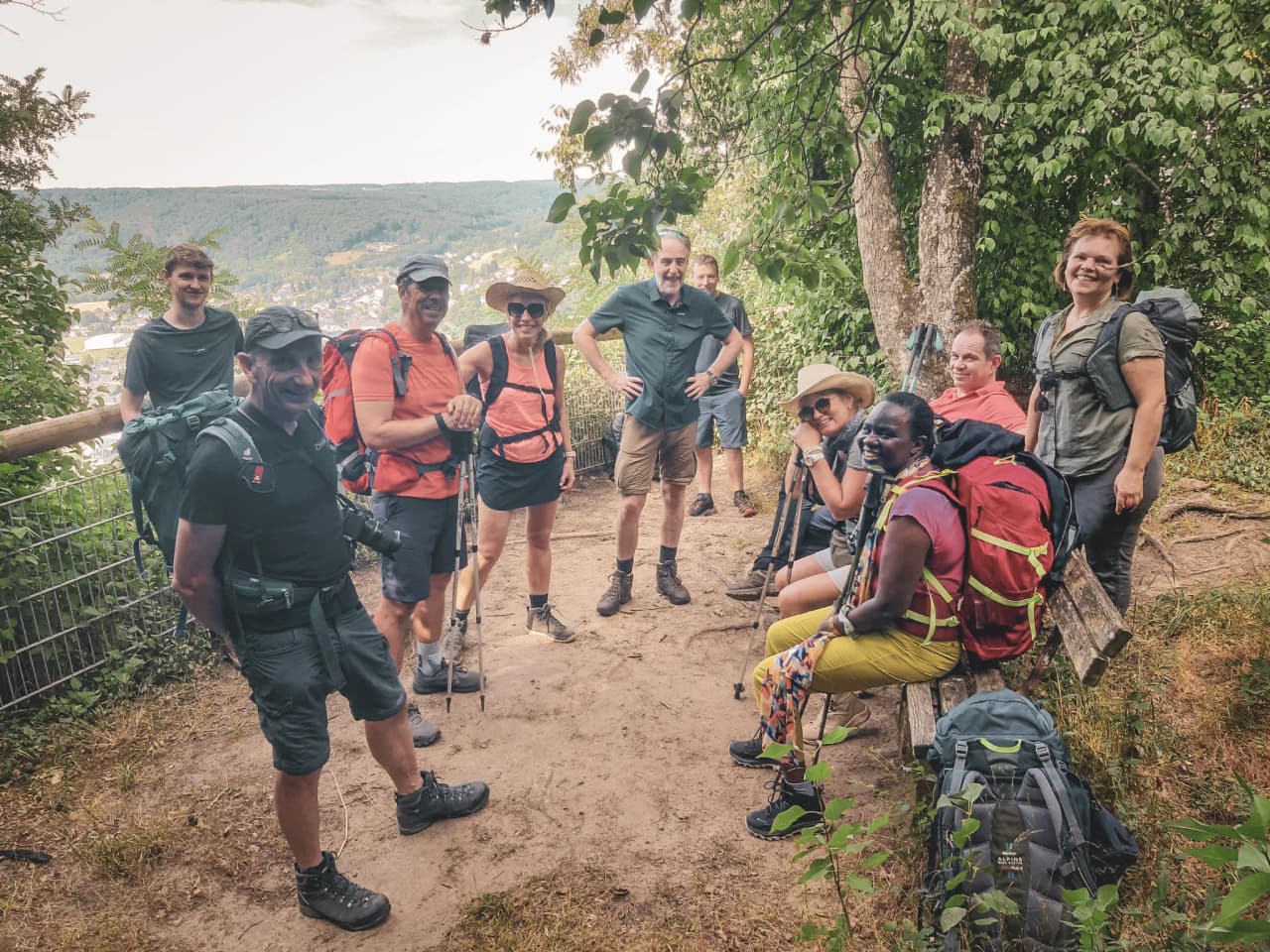 A group of smiling hikers take a break in Luxembourg's verdant Little Switzerland.