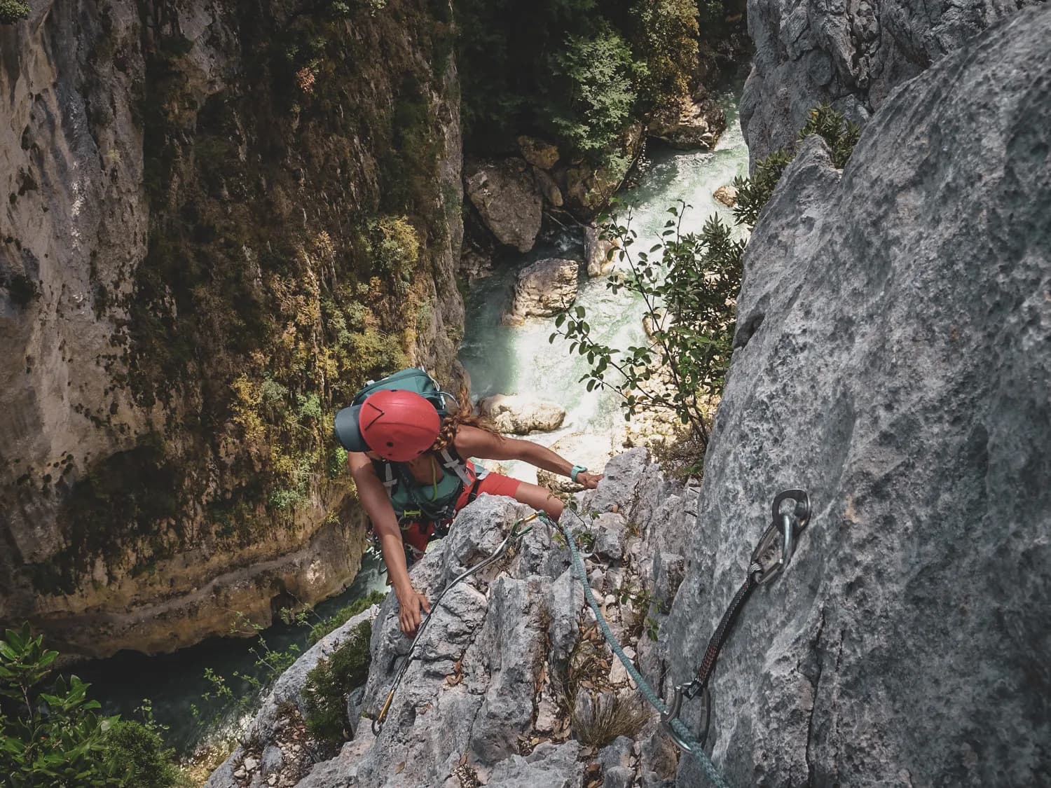 Climbing a steep cliff, surrounded by the verdant Gorges du Verdon and the river.