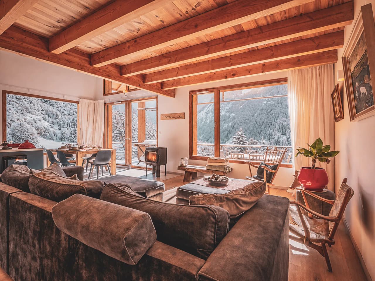 A warm and welcoming stay in a modern chalet, with views of snow-capped mountains and a cosy, inviting atmosphere.