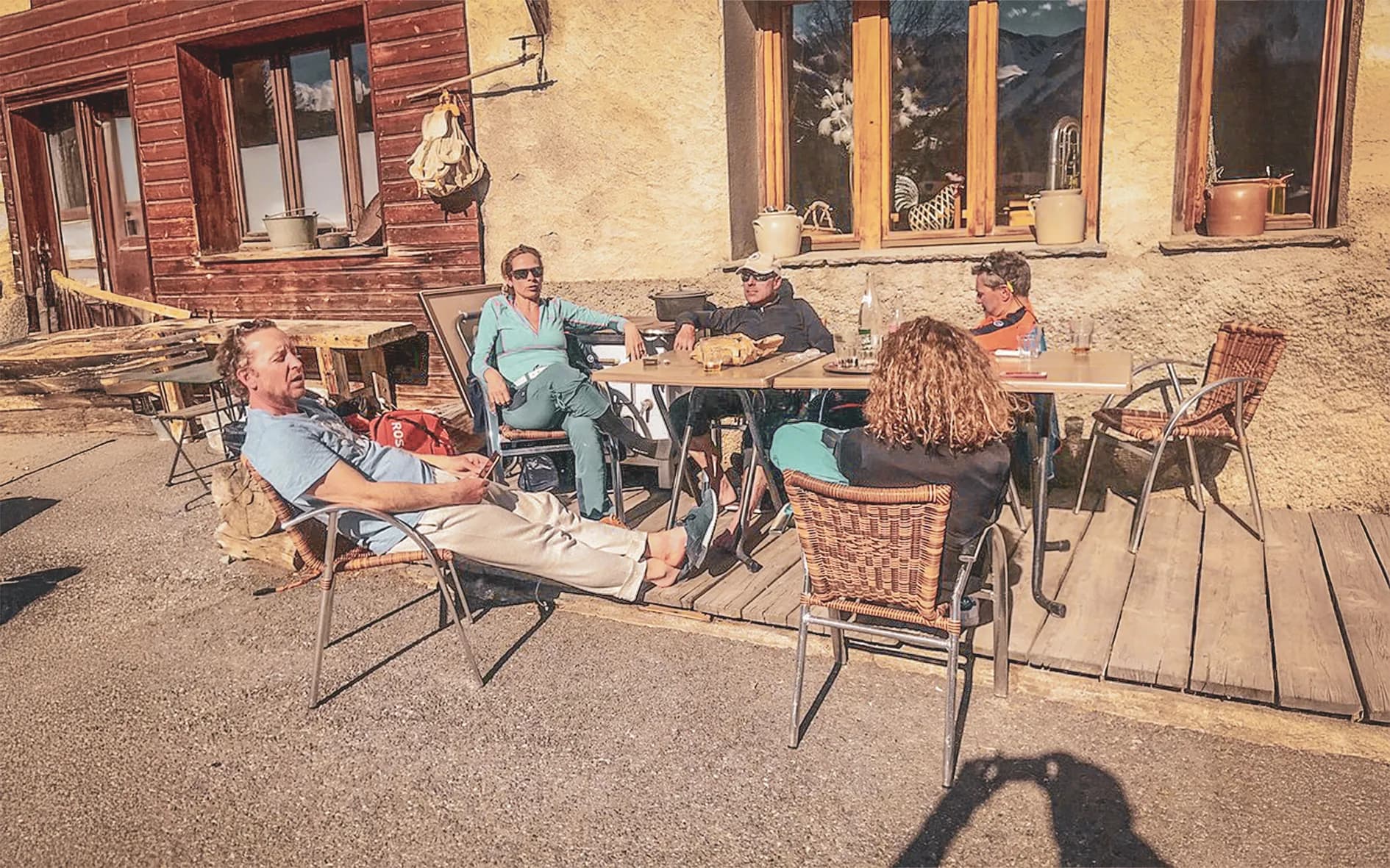 A group of walkers relaxing in the open air, soaking up the sun after a day's exploring.