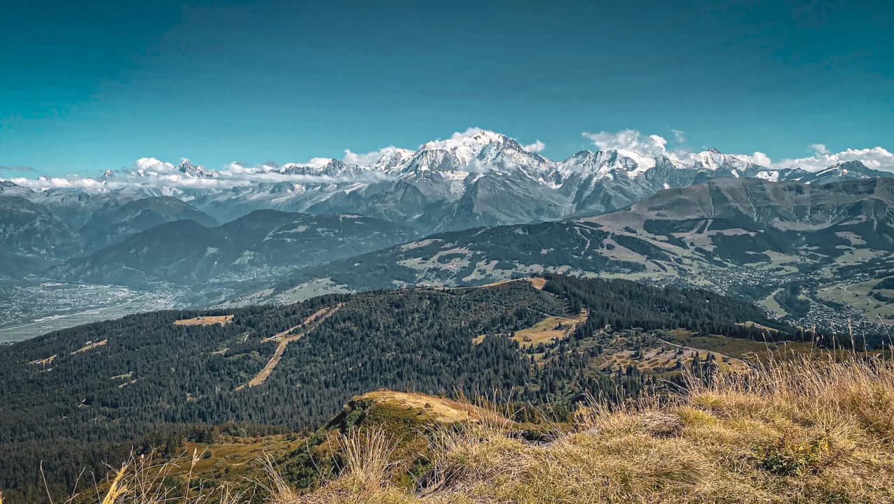 A breathtaking panorama of the Val d'Arly peaks, with the majestic Mont-Blanc in the background.