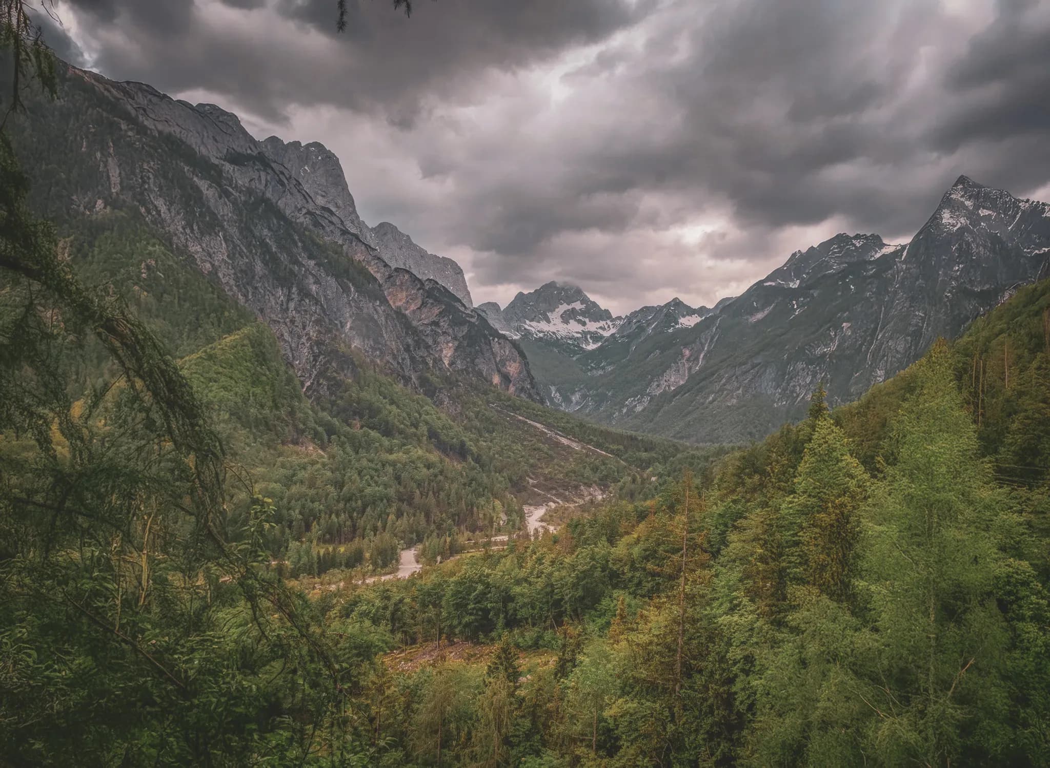 Green alpine valley under a cloudy sky, Slovenia's majestic landscapes.