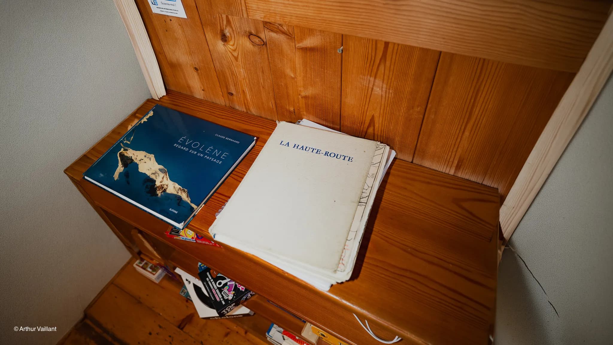 Two books on a wooden shelf, depicting the Alpine adventure from Chamonix to Zermatt.
