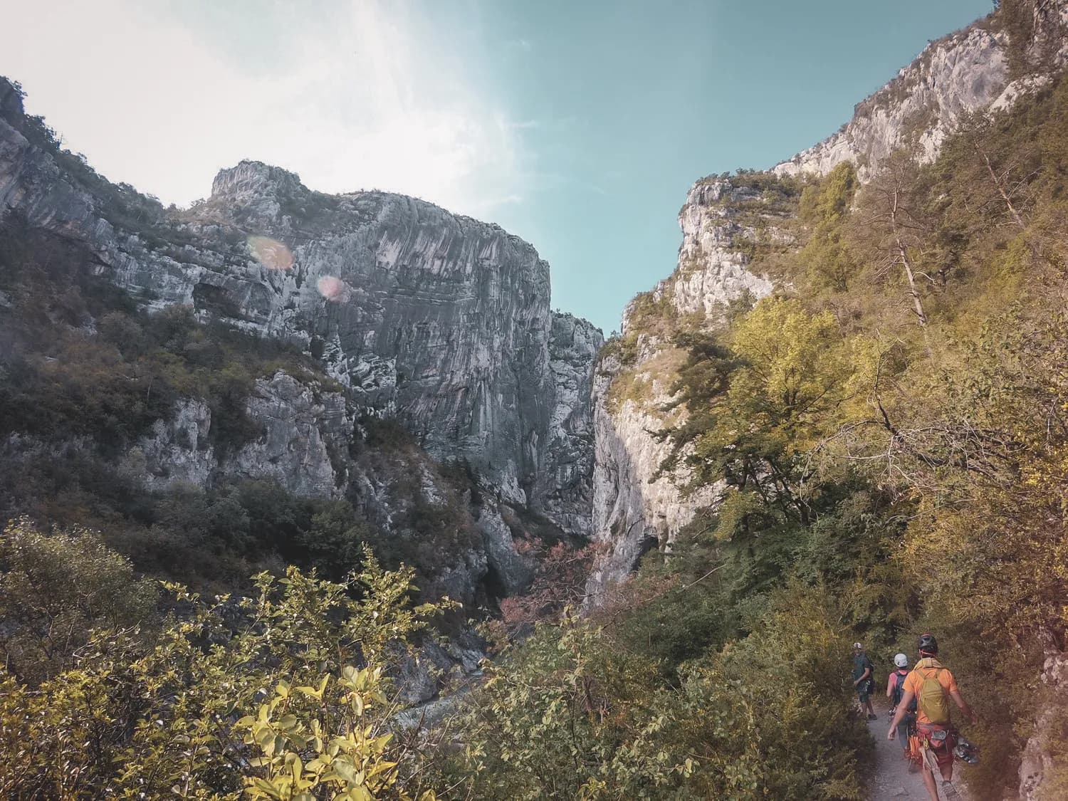 Hikers along majestic cliffs in the Gorges du Verdon, a wild adventure.