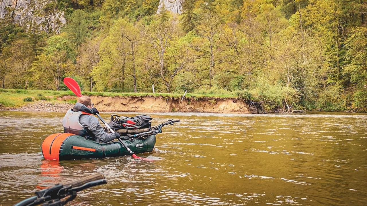 Kayaking adventure on the River Lesse, surrounded by lush, wild landscapes.