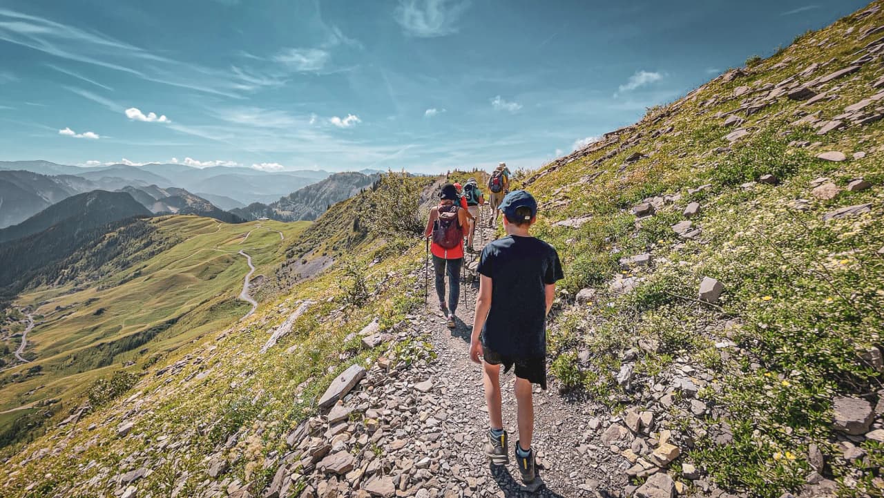 A hike along lush green ridges, with Alpine scenery and Mont Blanc in the background.