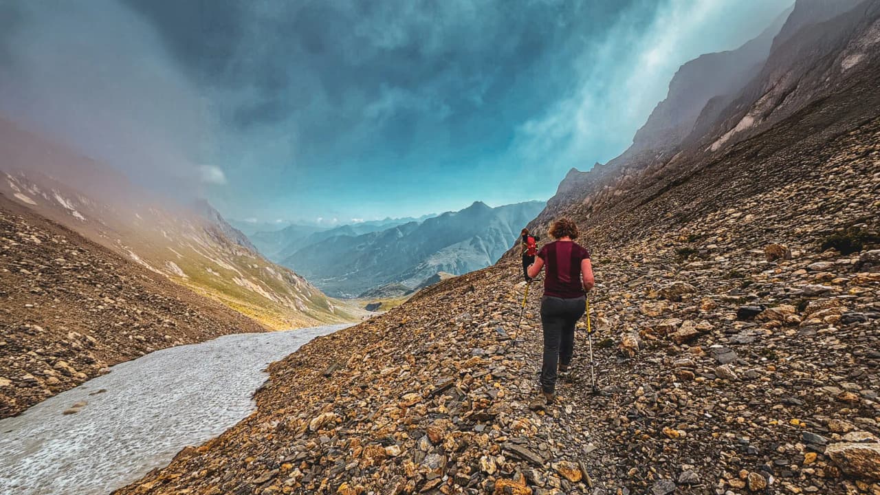Hiking on a mountain trail, between lush green valleys and majestic peaks.