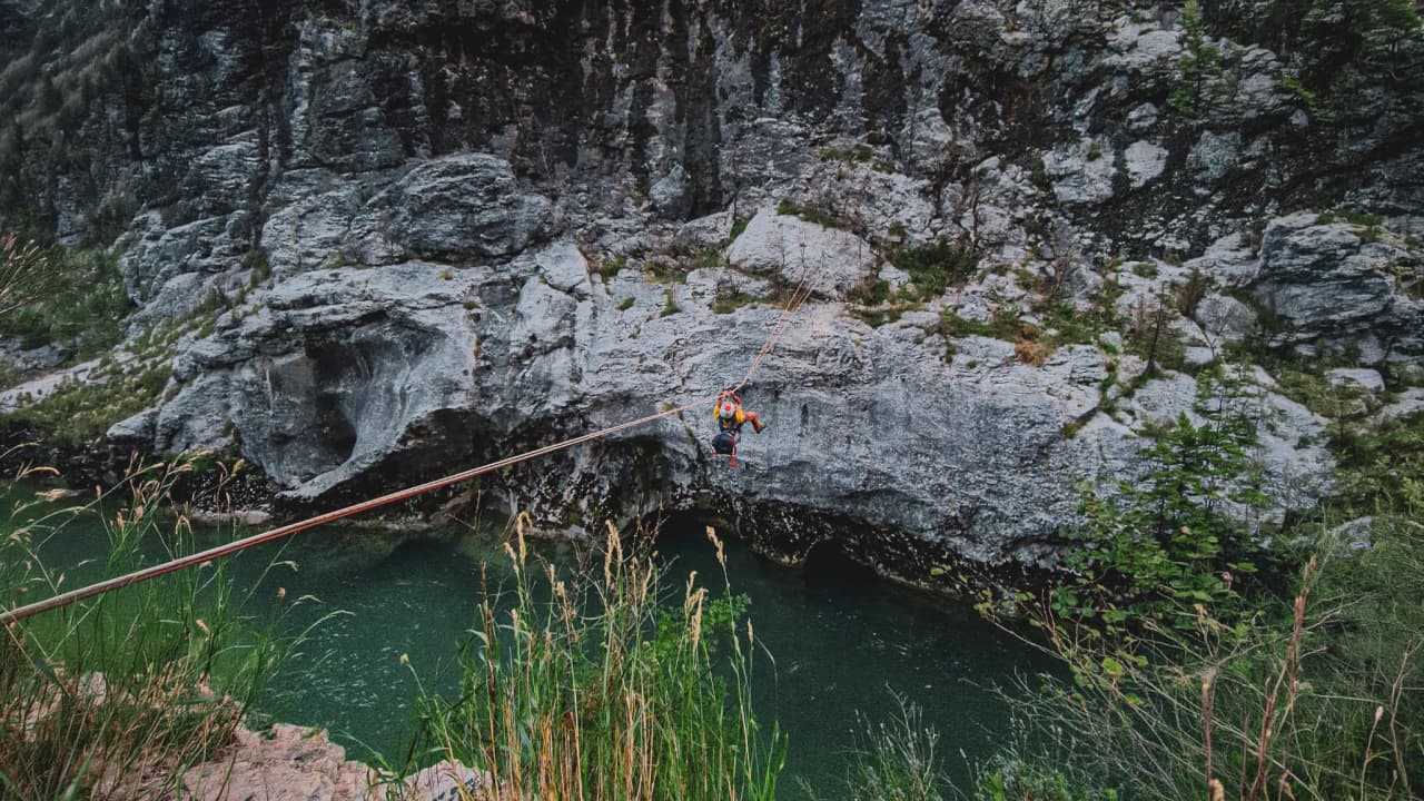 Climbing in the Gorges du Verdon, an adventurer suspended above emerald waters.