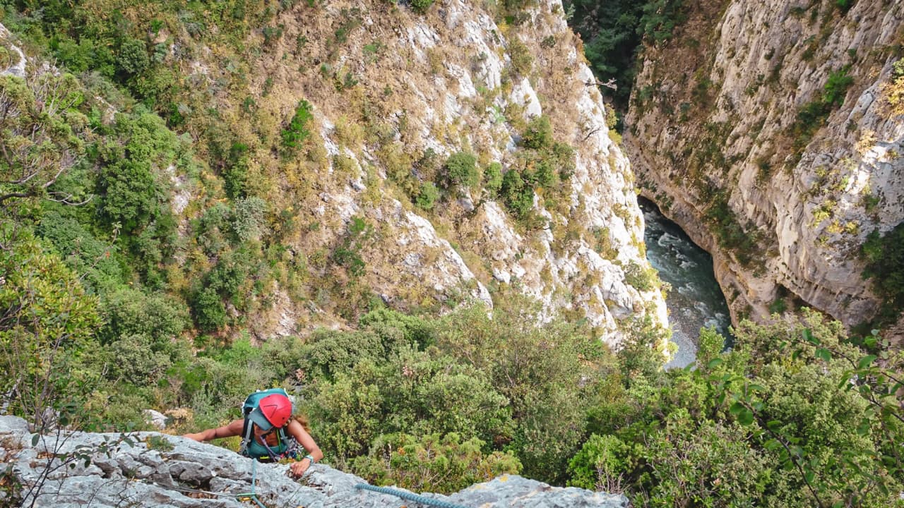 A climber in full ascent, overlooking the breathtaking scenery of the Gorges du Verdon.
