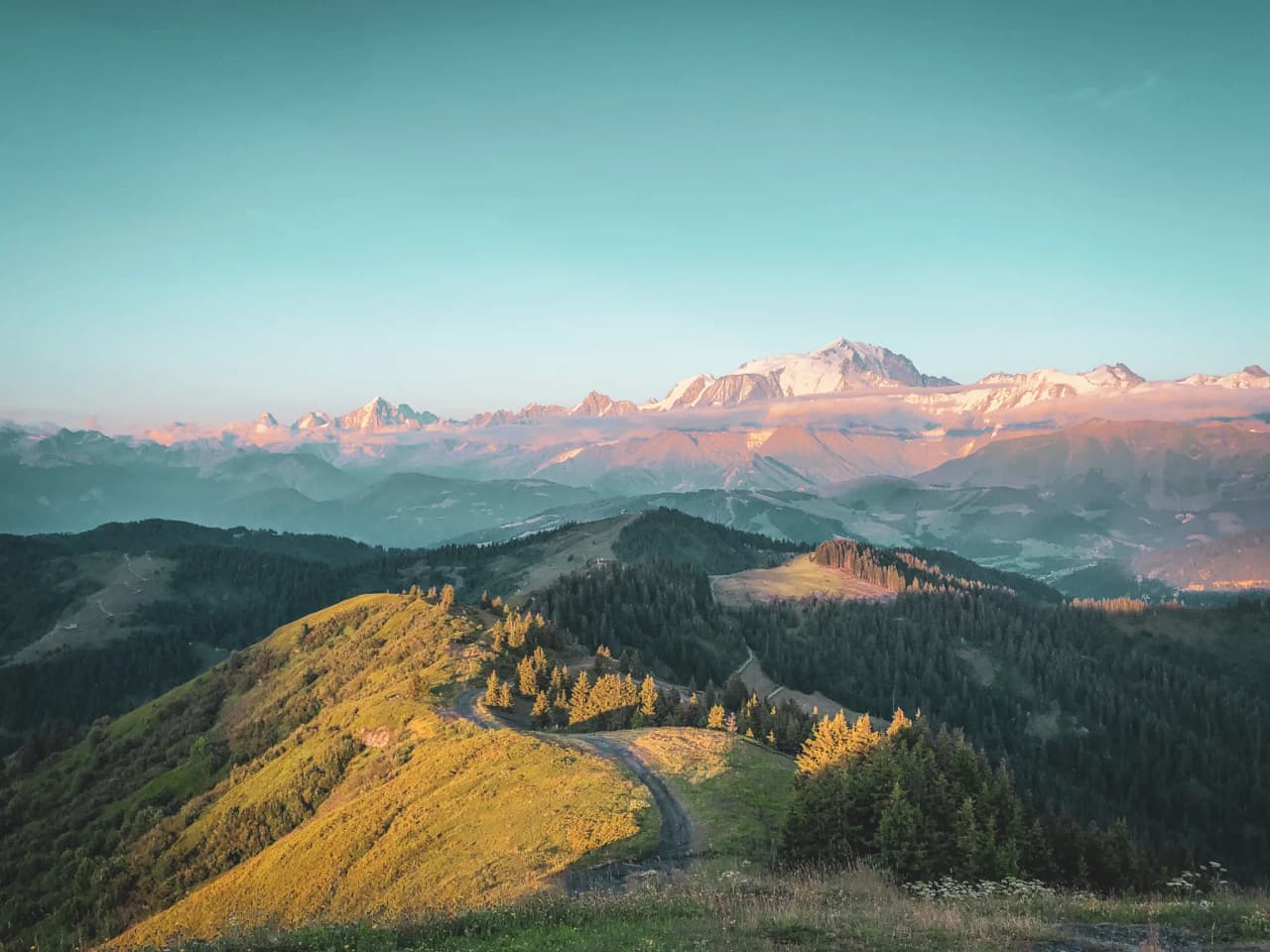 Spectacular Alpine panoramas facing Mont Blanc, lush green valleys and sun-drenched peaks.