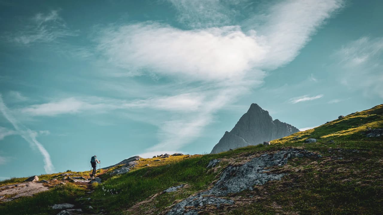 A sunny walk on the Lofoten Islands, with majestic mountains in the background.