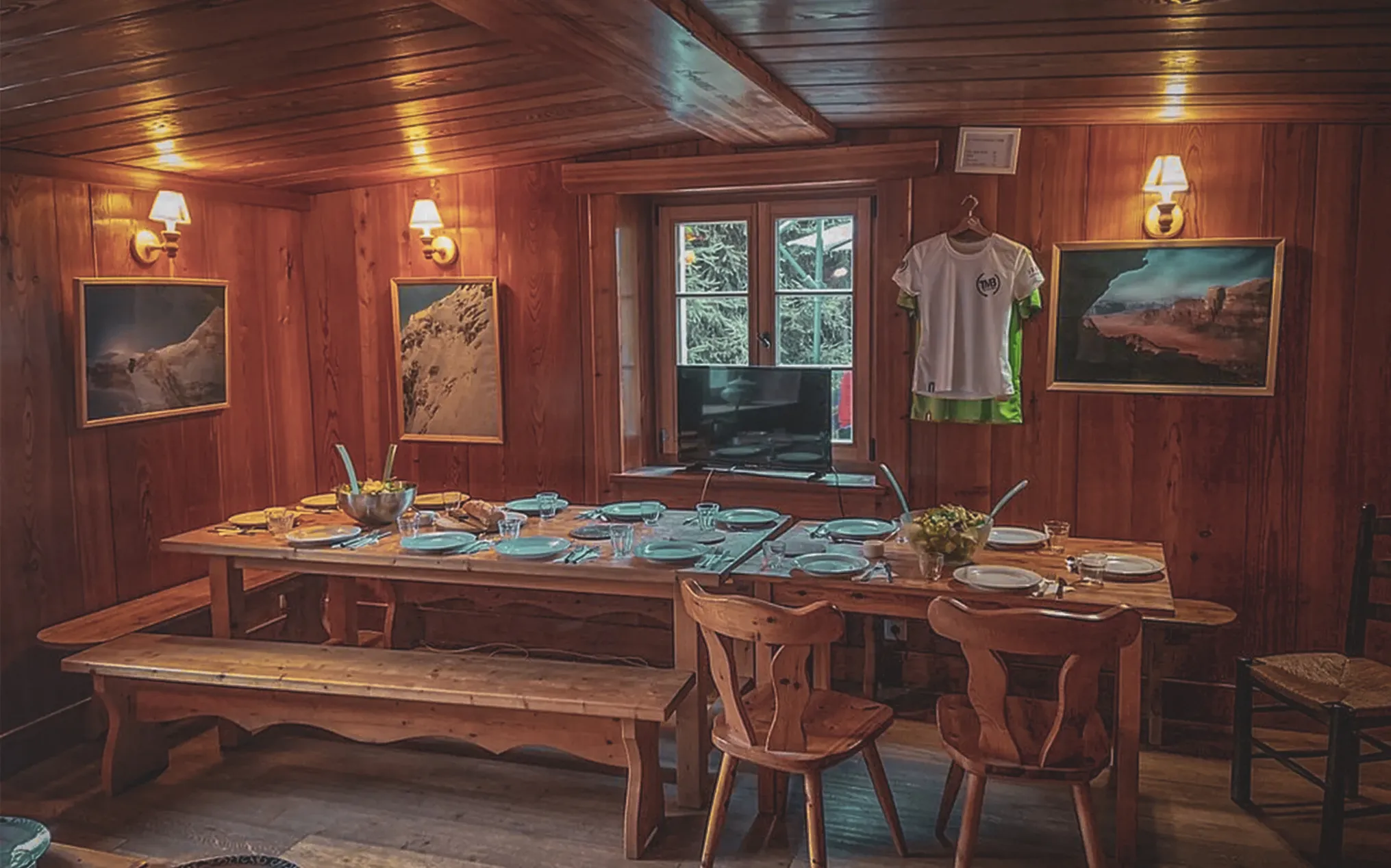 A cosy wooden room, ready for a convivial meal after a day's mountaineering.
