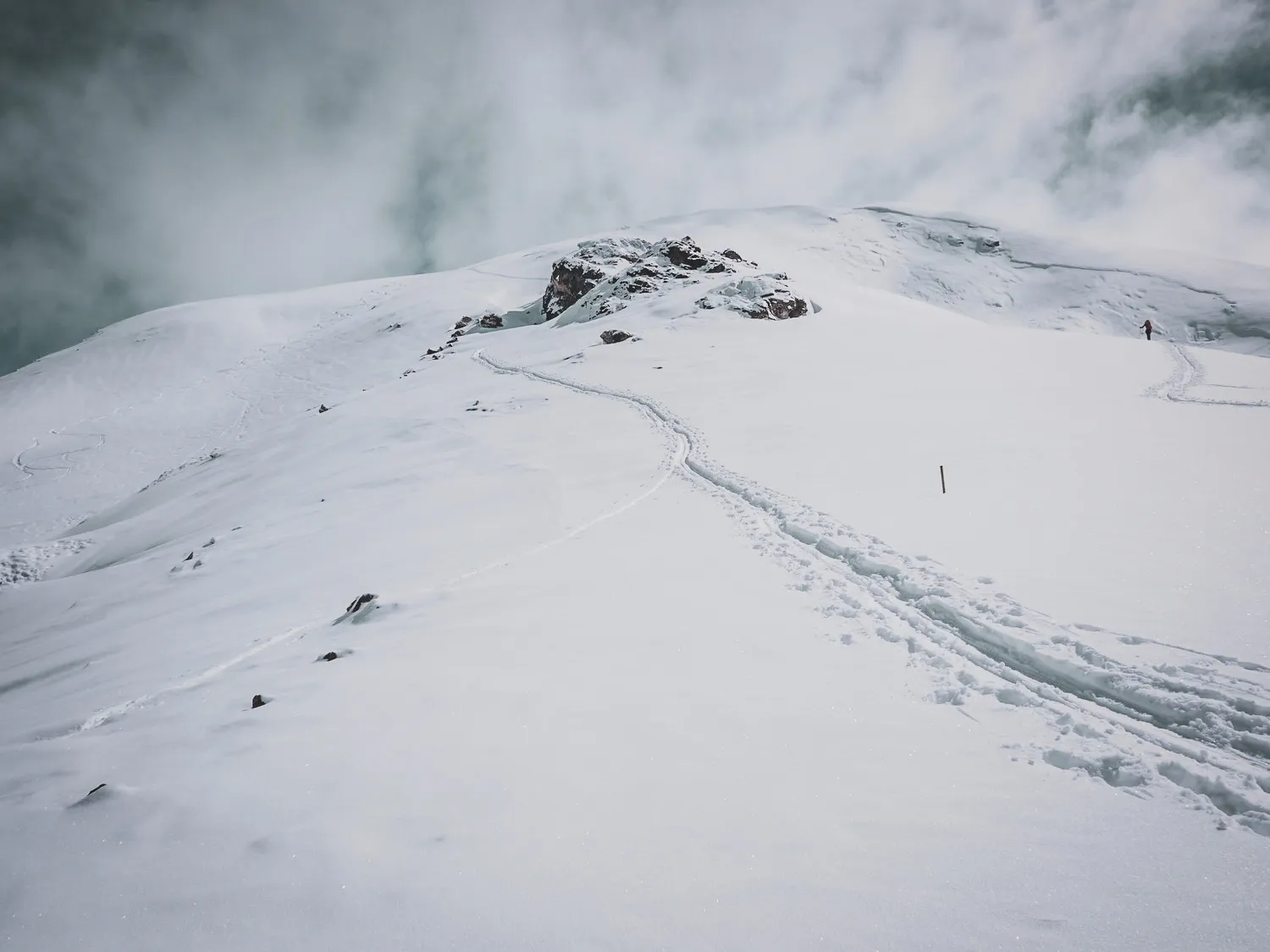 Snow-covered peaks under cloudy skies, an invitation to ski-touring adventure.