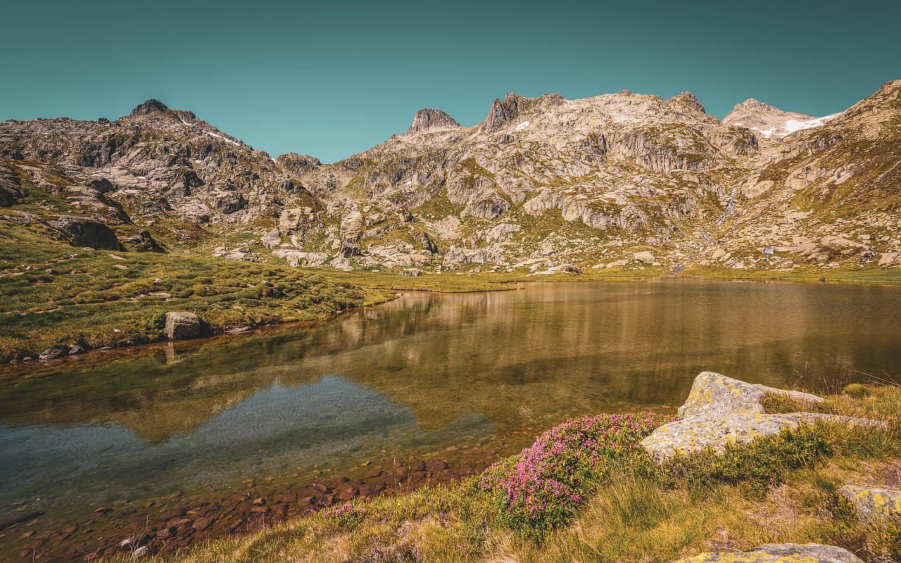 The serene lakes and majestic peaks of the Pyrenees are an invitation to adventure and nature.